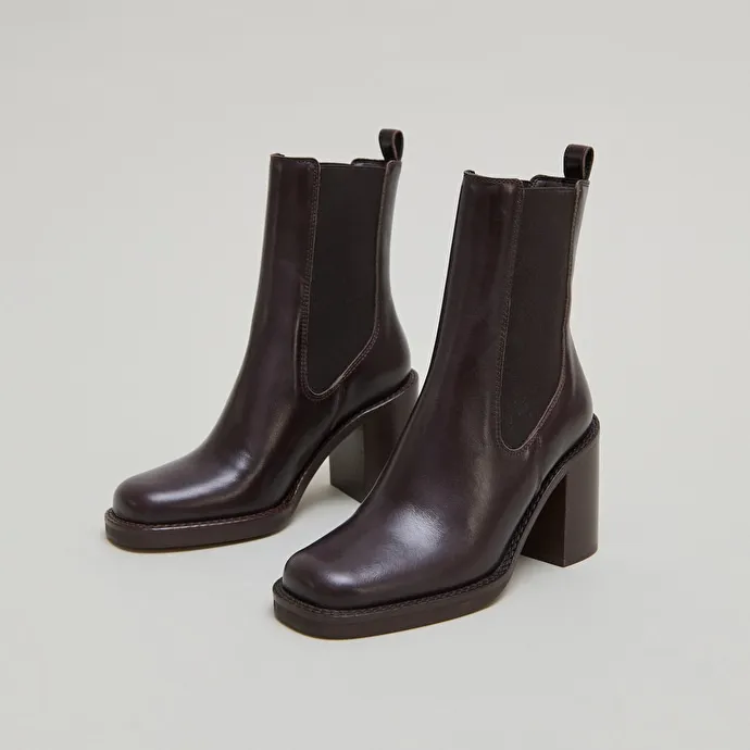 Ankle boots with overflowing heels in dark brown leather