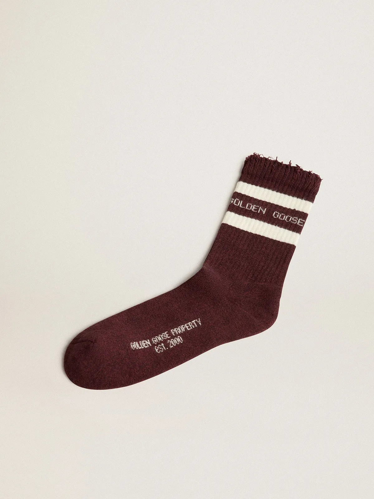 Burgundy socks with distressed details and worn white stripes